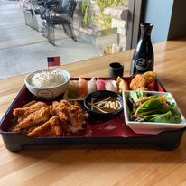 KOMO Sushi bento box with assorted Japanese dishes