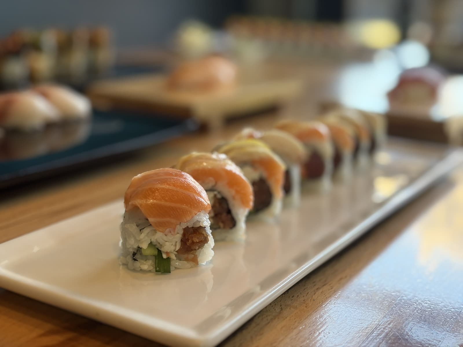 Salmon-topped sushi roll plated to order